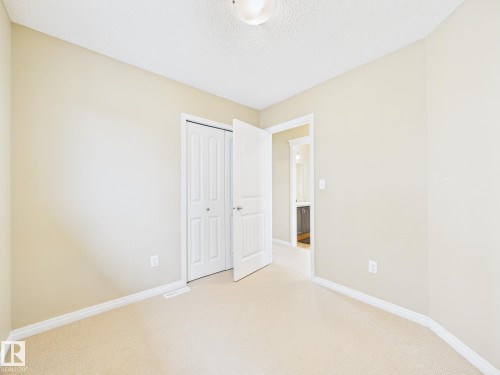 Well-lit room featuring neutral-toned walls, carpeted flooring, and white trim - 9073 Scott Crescent, Edmonton, AB - Indoor Photo Showing Other Room