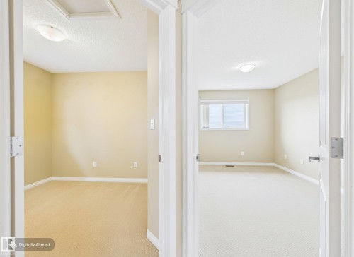 Two rooms featuring carpeted floors, light-colored walls, and overhead lighting fixtures - 9073 Scott Crescent, Edmonton, AB - Indoor Photo Showing Other Room