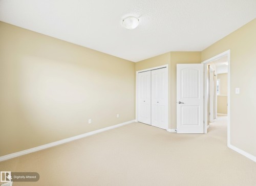 This room features neutral-toned walls, light-colored carpeting, a ceiling-mounted light fixture, white trim, and a white interior door - 9073 Scott Crescent, Edmonton, AB - Indoor Photo Showing Other Room