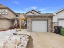 The property features an attached garage with a stone facade, complemented by siding on the upper portion - 9073 Scott Crescent, Edmonton, AB  - Outdoor 