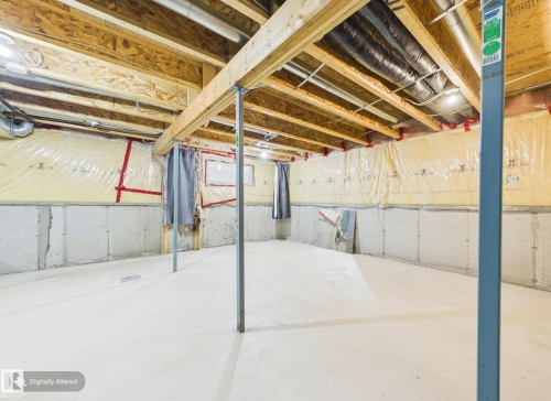 Unfinished basement with concrete walls, exposed wooden ceiling joists, and a concrete floor - 9073 Scott Crescent, Edmonton, AB - Indoor Photo Showing Basement
