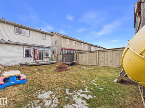 The property features a backyard with a wooden deck and privacy fencing - 9073 Scott Crescent, Edmonton, AB - Outdoor With Deck Patio Veranda With Exterior