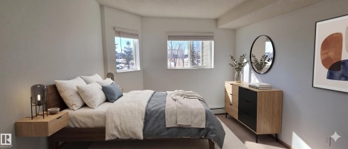 The bedroom features light-colored walls and windows with blinds - 208A 260 Spruce Ridge Road, Spruce Grove, AB - Indoor Photo Showing Bedroom
