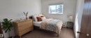 This room features carpeting, a window providing natural light, and white walls - 208A 260 Spruce Ridge Road, Spruce Grove, AB  - Indoor Photo Showing Bedroom 