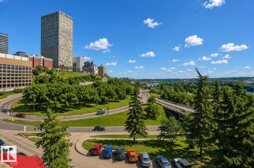 A scenic aerial view showcasing the surrounding urban landscape with a variety of buildings, green spaces, and a winding roadway - 604 9918 101 Street, Edmonton, AB - Outdoor With View