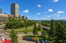 A scenic aerial view showcasing the surrounding urban landscape with a variety of buildings, green spaces, and a winding roadway - 604 9918 101 Street, Edmonton, AB  - Outdoor With View 