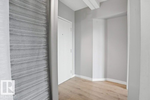 Entryway featuring a light wood-style floor, a white door, and light gray walls - 604 9918 101 Street, Edmonton, AB - Indoor Photo Showing Other Room