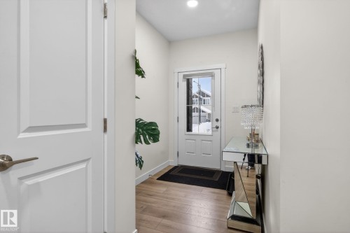 Inviting entryway featuring light-toned flooring, white walls, and a white front door with a window - 7344 177 Avenue, Edmonton, AB - Indoor Photo Showing Other Room