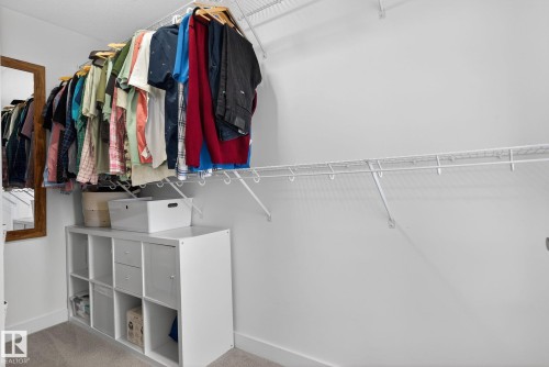 The closet features white wire shelving and a hanging rod, with a white storage unit below - 7344 177 Avenue, Edmonton, AB - Indoor With Storage