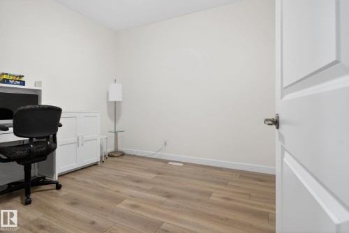 This room features light wood flooring and white walls, creating a bright and airy atmosphere - 7344 177 Avenue, Edmonton, AB - Indoor Photo Showing Office