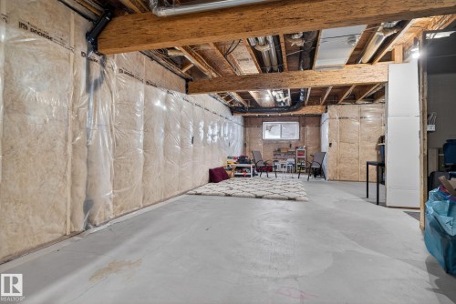 Spacious unfinished basement with exposed wooden beams and a concrete floor - 7344 177 Avenue, Edmonton, AB - Indoor Photo Showing Basement