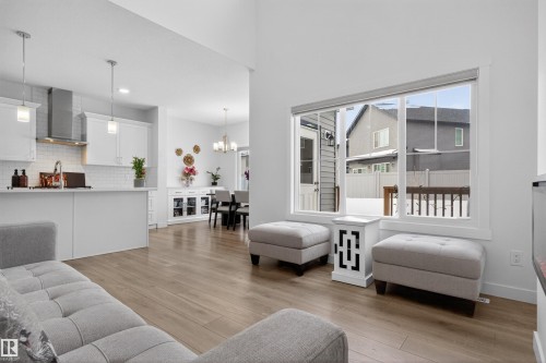 Open concept living area featuring light-toned flooring and a large window providing views of the outdoors - 7344 177 Avenue, Edmonton, AB - Indoor Photo Showing Living Room