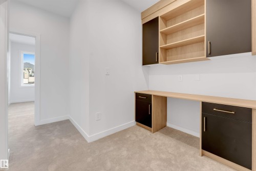 This room features neutral carpeted flooring and white walls, creating a versatile space - 22 Meadowgrove Landing, Spruce Grove, AB - Indoor Photo Showing Other Room