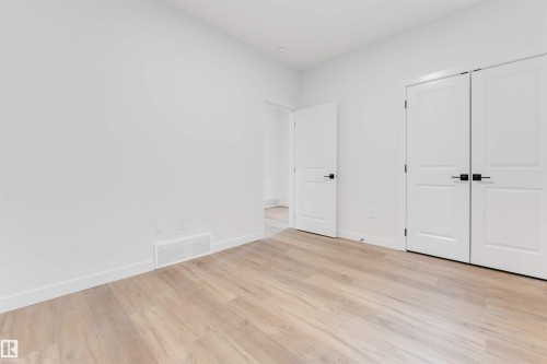 This room features light-toned wood flooring, white walls, and white trim - 22 Meadowgrove Landing, Spruce Grove, AB - Indoor Photo Showing Other Room