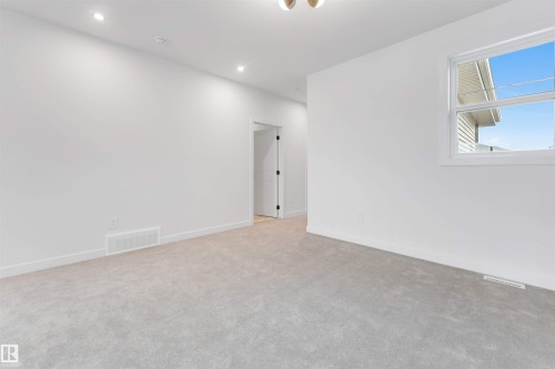 This room features light gray carpeting, white walls, and recessed lighting - 22 Meadowgrove Landing, Spruce Grove, AB - Indoor Photo Showing Other Room