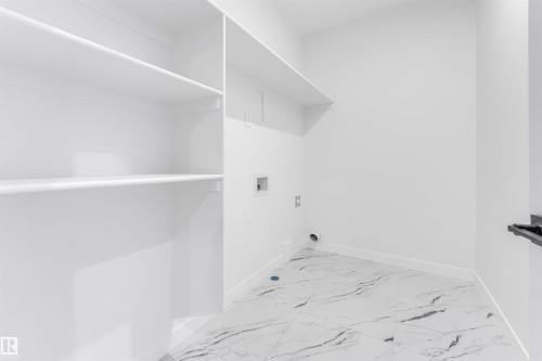 Utility room featuring white walls, white shelving, and tile flooring - 22 Meadowgrove Landing, Spruce Grove, AB - Indoor With Storage