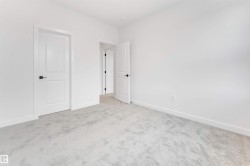 This interior space features light gray carpeting and white walls - 
