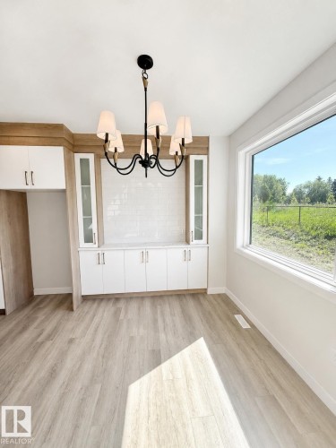 Built-in cabinetry with glass-front uppers and white subway tile backsplash - 22 Meadowgrove Landing, Spruce Grove, AB - Indoor Photo Showing Other Room
