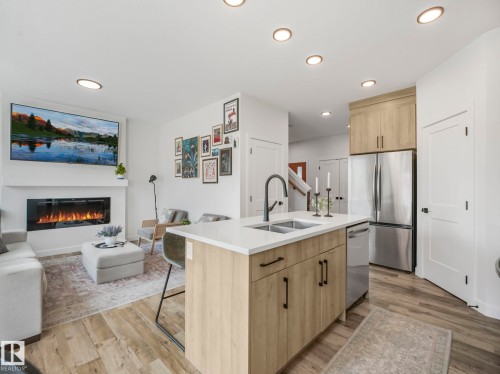 201 Starling, Fort Saskatchewan, AB - Indoor Photo Showing Kitchen With Fireplace With Double Sink