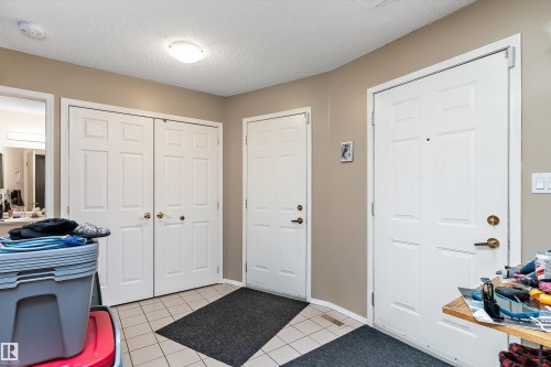 Entryway featuring a white paneled door, light-colored walls, and tiled flooring - 5737 189 Street, Edmonton, AB - Indoor Photo Showing Other Room