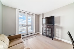 The living area features light-colored flooring and a patio door that opens to an outdoor space - 