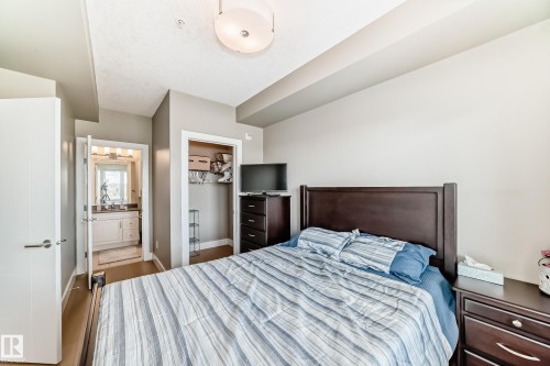 Bedroom featuring light-colored walls and wood flooring - 506 11080 Ellerslie Road, Edmonton, AB - Indoor Photo Showing Bedroom