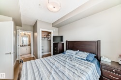 Bedroom featuring light-colored walls and wood flooring - 