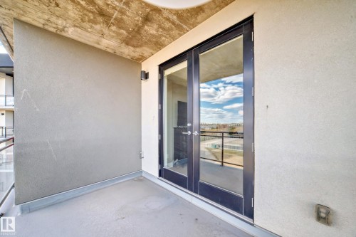 This property features a balcony with a concrete floor and textured walls - 506 11080 Ellerslie Road, Edmonton, AB - Outdoor With Balcony With Exterior