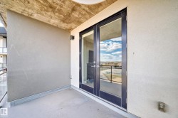 This property features a balcony with a concrete floor and textured walls - 