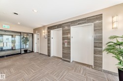 The property features a stylish lobby with patterned flooring, two elevators, and modern wall sconces providing ambient lighting - 