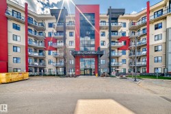 The property features a modern building exterior with a striking red, gray, and cream color palette - 