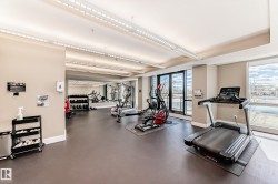 The property features a well-equipped fitness center with large windows, offering natural light and views - 