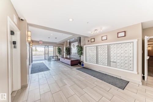 The property features a bright and inviting lobby with light-toned tiled flooring - 506 11080 Ellerslie Road, Edmonton, AB - Indoor Photo Showing Other Room