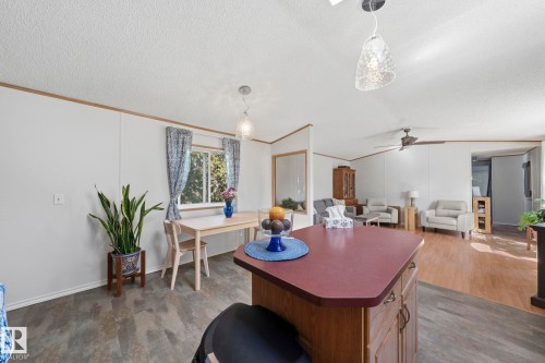The property features an open-concept living area with diverse flooring, including wood-look and patterned surfaces - 66 Evergreen Park, Edmonton, AB - Indoor