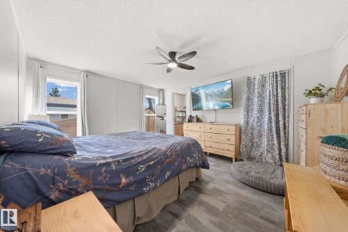 The property features a bedroom with light gray flooring, white walls, and a ceiling fan - 66 Evergreen Park, Edmonton, AB - Indoor Photo Showing Bedroom