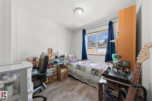 This room features a window providing natural light, a neutral-toned ceiling, and textured flooring - 66 Evergreen Park, Edmonton, AB - Indoor Photo Showing Bedroom
