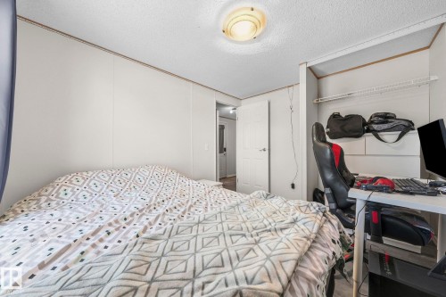 This room features light-colored walls and a textured ceiling - 66 Evergreen Park, Edmonton, AB - Indoor Photo Showing Bedroom