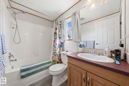 Bathroom featuring a vanity with a white oval sink and a dark countertop, a toilet, and a shower and bathtub combination - 66 Evergreen Park, Edmonton, AB - Indoor Photo Showing Bathroom