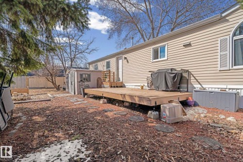 The property features siding exterior, a wood deck, and a detached shed in the yard - 66 Evergreen Park, Edmonton, AB - Outdoor With Deck Patio Veranda