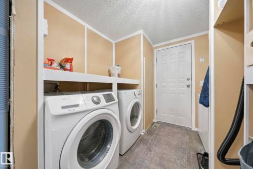 Utility space featuring a washer, a dryer, and a white paneled door - 66 Evergreen Park, Edmonton, AB - Indoor Photo Showing Laundry Room