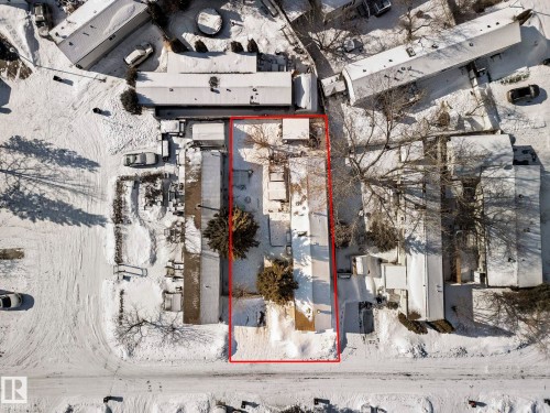 Aerial view of the property, outlined in red, featuring several structures and mature trees - 66 Evergreen Park, Edmonton, AB - 