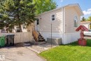 The property features light-colored horizontal siding, a well-maintained lawn, and a light-colored picket fence - 66 Evergreen Park, Edmonton, AB  - Outdoor 