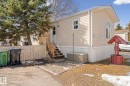 The property features beige siding, a white picket fence, and a wooden porch with stairs - 66 Evergreen Park, Edmonton, AB  - Outdoor 