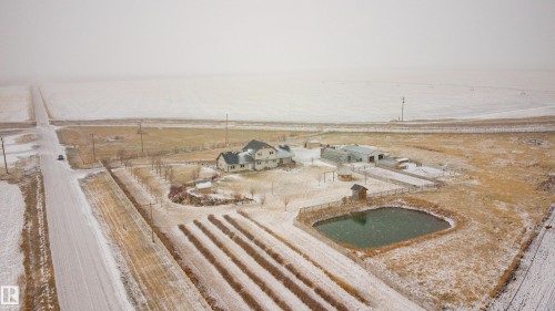 This expansive property includes a main residence, an outbuilding, and a pond - 114039 Range Road 221, Rural Lethbridge County, AB - 