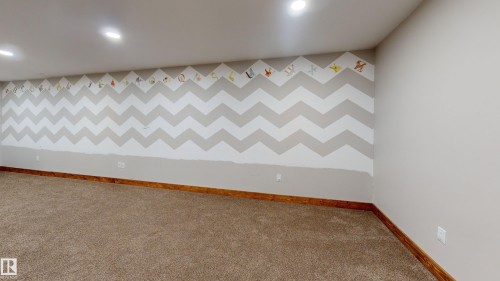 Spacious room featuring carpeted flooring, light-colored walls, and recessed lighting - 114039 Range Road 221, Rural Lethbridge County, AB - Indoor Photo Showing Other Room