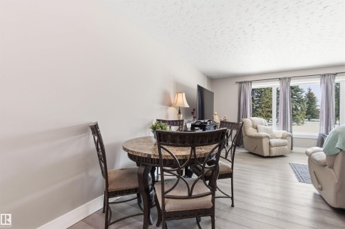 The property features light-colored walls and flooring throughout the open living area - 12904 95 Street, Edmonton, AB - Indoor