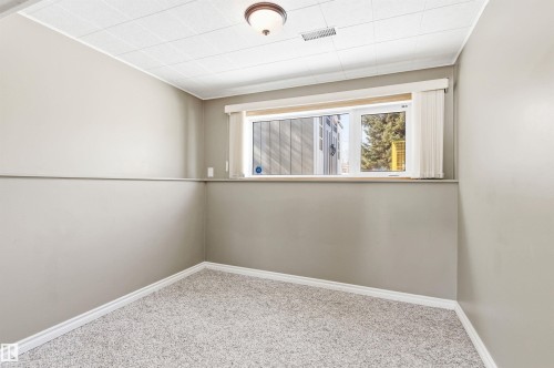 This room features light grey walls, white trim, and light-colored carpet - 12904 95 Street, Edmonton, AB - Indoor Photo Showing Other Room