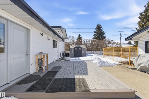 The property features a spacious rear deck, white siding, and a shed in the yard - 12904 95 Street, Edmonton, AB - Outdoor With Exterior