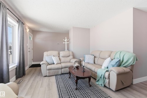 The living room features light-colored flooring and neutral-toned walls, creating a bright atmosphere - 12904 95 Street, Edmonton, AB - Indoor Photo Showing Living Room