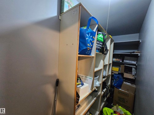 Storage area featuring built-in shelving units - 8 10616 123 Street, Edmonton, AB - Indoor